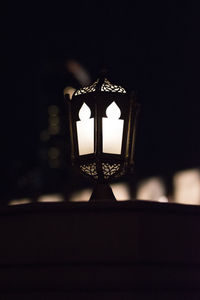 Close-up of illuminated lamp in darkroom