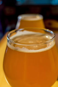 Close-up of beer in wineglasses on table