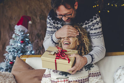 Young man with christmas tree in box