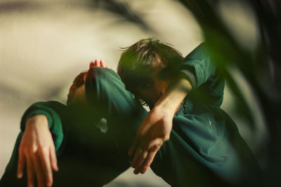 Close-up of two men gesturing against wall