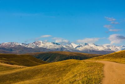 Scenic view of mountains against blue sky