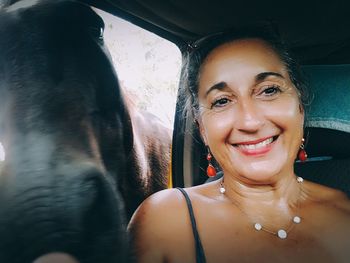 Portrait of a smiling young woman in car