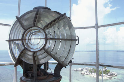 View of sea against sky seen through window