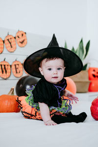 Portrait of cute girl wearing costume at home