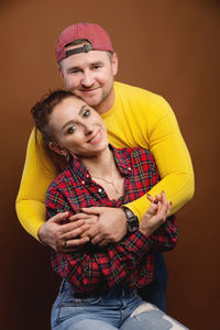 Portrait of young couple against gray background