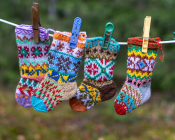 Photography with knitted socks, socks hanging on a rope, handicraft concept, knitting as a hobby