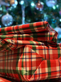 Close-up of multi colored gifts under a christmas tree