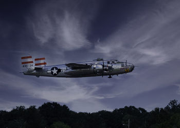 Low angle view of airplane flying against sky