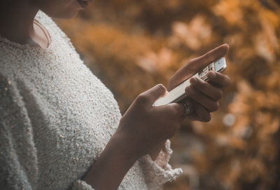 Close-up of hand holding cigarette