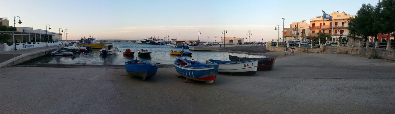 transportation, nautical vessel, water, moored, mode of transport, sea, boat, sky, built structure, incidental people, building exterior, harbor, architecture, in a row, beach, outdoors, pier, travel, clear sky, empty