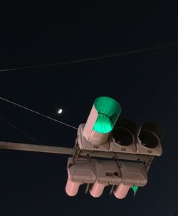 Low angle view of telephone against black background