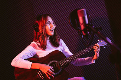 Young singer singing song at stage