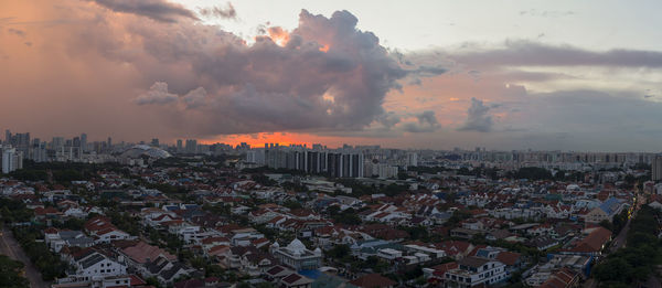 Cityscape against cloudy sky