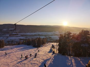 Scenic view of snow covered mountains against sky during sunset