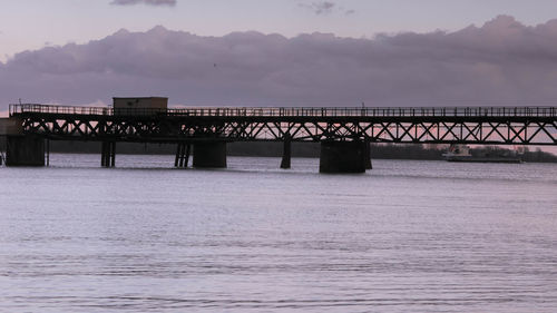 Bridge over sea against sky