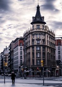 View of city street and buildings against sky