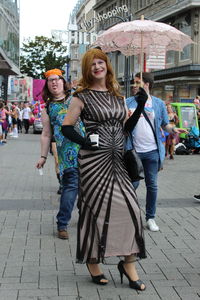 Full length portrait of happy friends in city