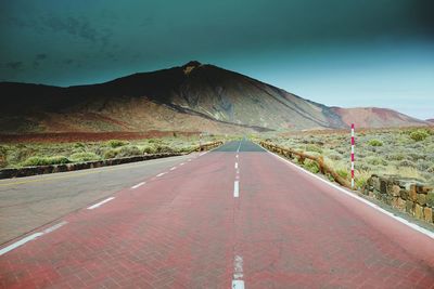 Road amidst mountains against sky