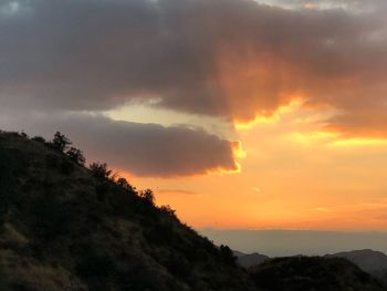 Scenic view of silhouette mountain against dramatic sky