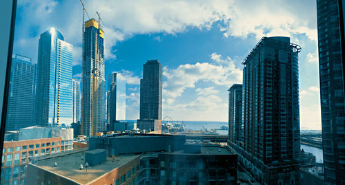 Panoramic view of buildings in city against sky