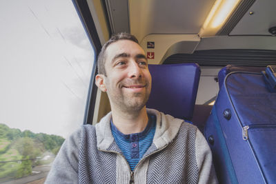 Portrait of happy man sitting in car