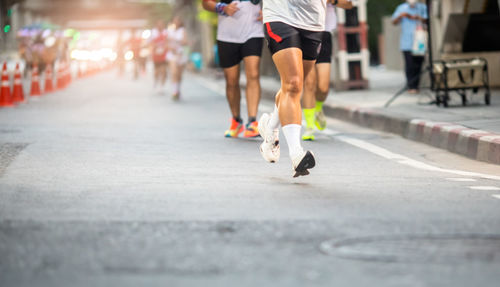 Low section of people walking on street