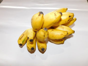 High angle view of yellow fruits on white background