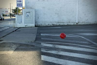 Red balloons on road in city