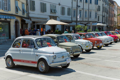 Cars on street against buildings in city