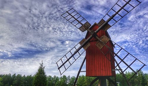 Low angle view of traditional windmill against sky