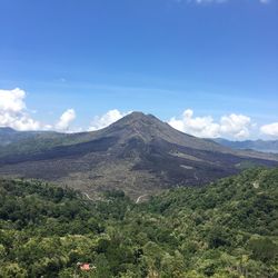 Scenic shot of mountain range against blue sky