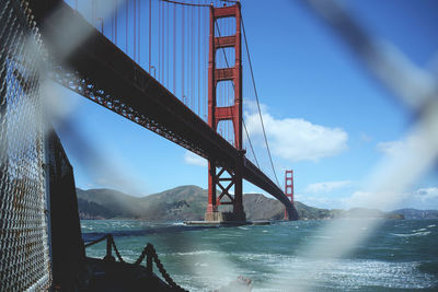 Golden gate bridge over river against sky