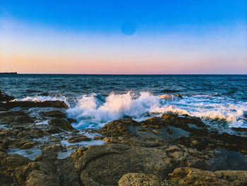 Scenic view of sea against sky during sunset