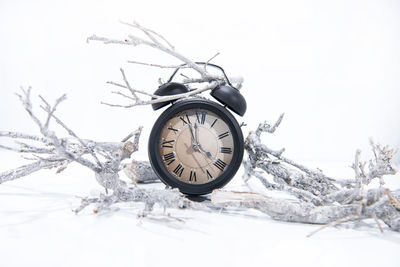 Close-up of clock on snow covered land