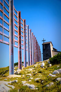 Low angle view of buildings against clear blue sky