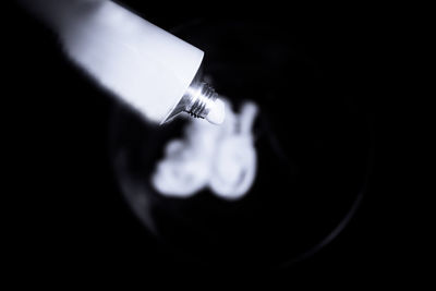 High angle view of person hand in darkroom