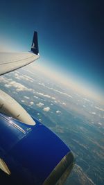 Cropped image of airplane flying over landscape