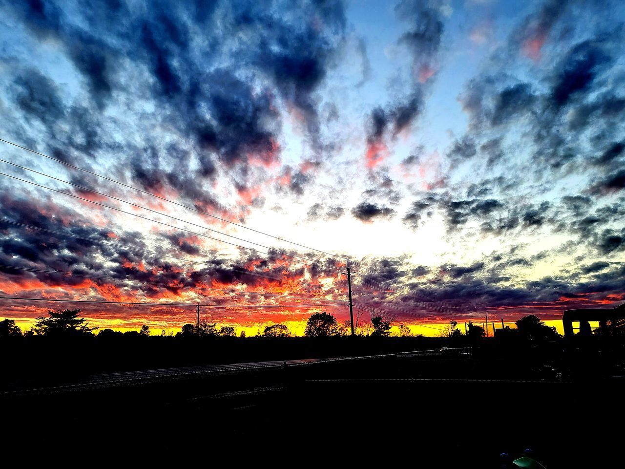 SCENIC VIEW OF DRAMATIC SKY OVER CITY DURING SUNSET