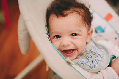 Close-up of cute baby in stroller at home