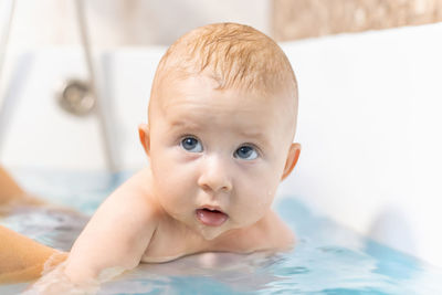 Close-up of baby girl taking bath