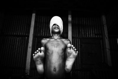 Low angle portrait of shirtless man standing