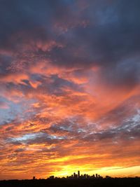 Low angle view of silhouette buildings against sky during sunset