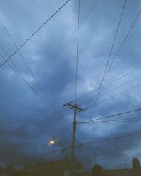 Low angle view of electricity pylon against sky