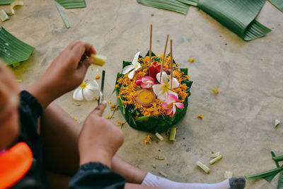 Low section of man preparing flower decoration