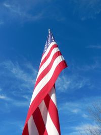 Low angle view of flag against blue sky