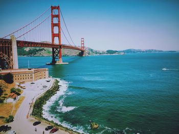 Golden gate bridge over sea against clear blue sky