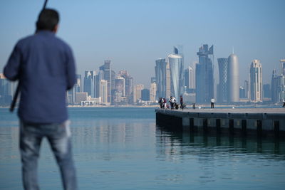 Rear view of people looking at sea
