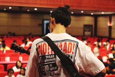 Rear view of man standing at music concert