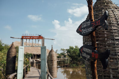 View of flags hanging on wood against sky