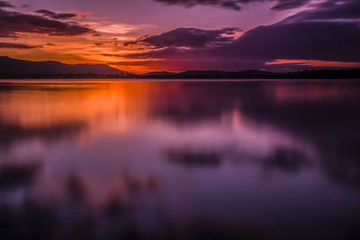 Scenic view of lake against romantic sky at sunset